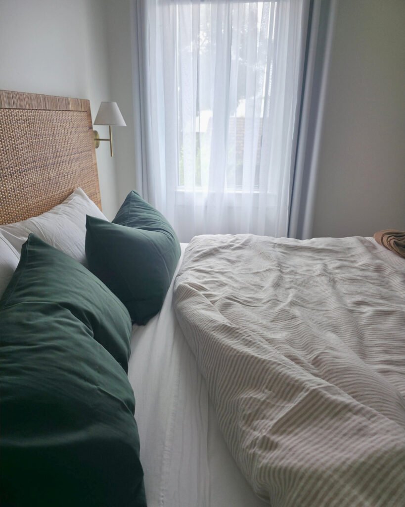 Sandstone linen cover, moss green pillowcases, angled (lifestyle)